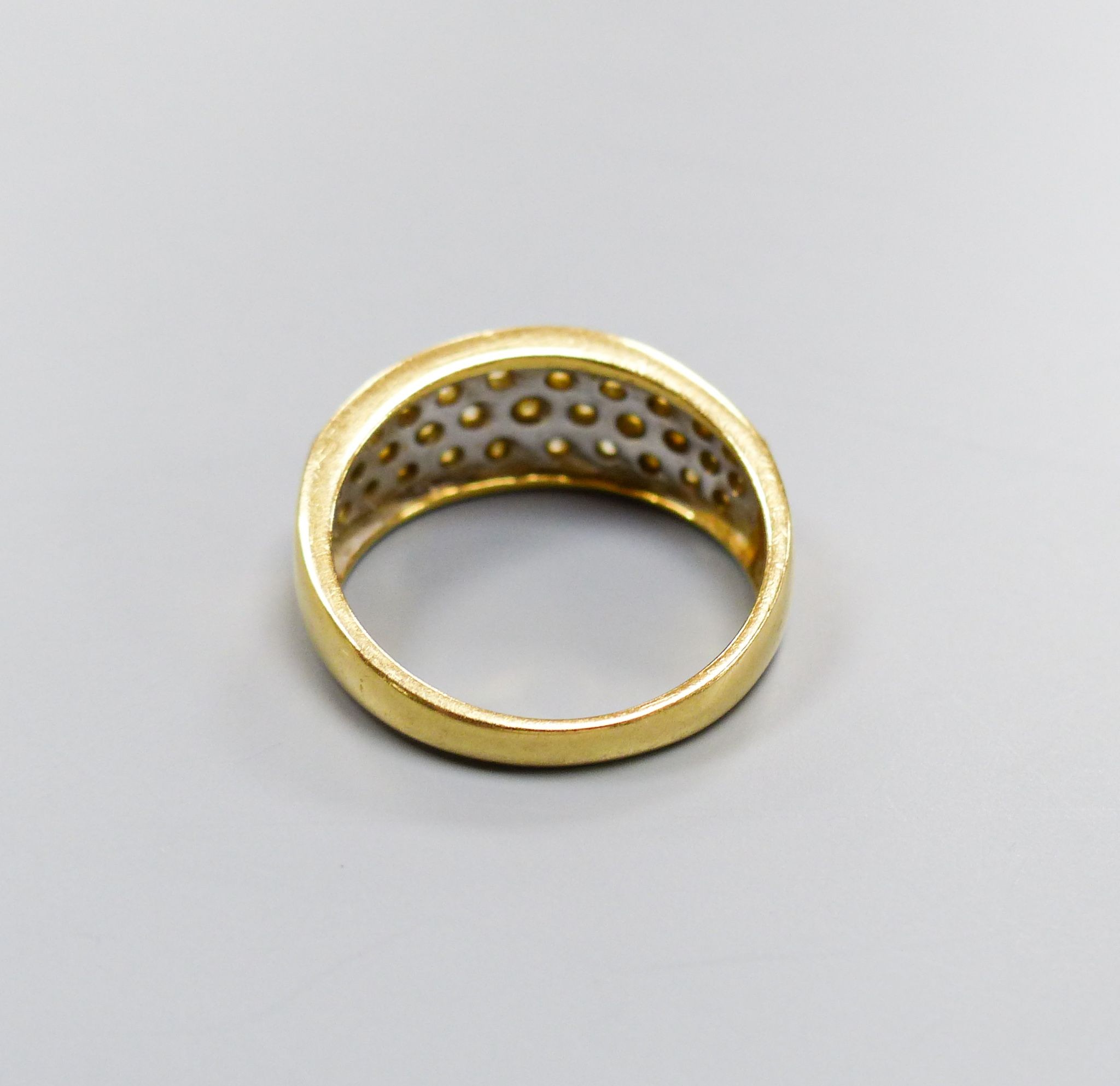 A modern 18ct gold and diamond encrusted half hoop ring, total diamond weight approx. 1.00ct, size N, gross 5.4 grams.